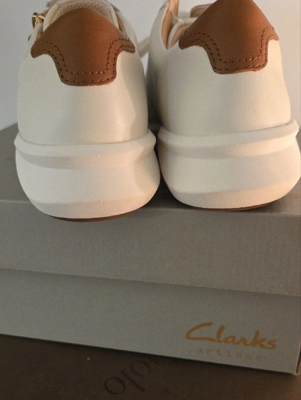 Clarks Cream Leather Sneakers with Brown Heel Accent and Gold Zip